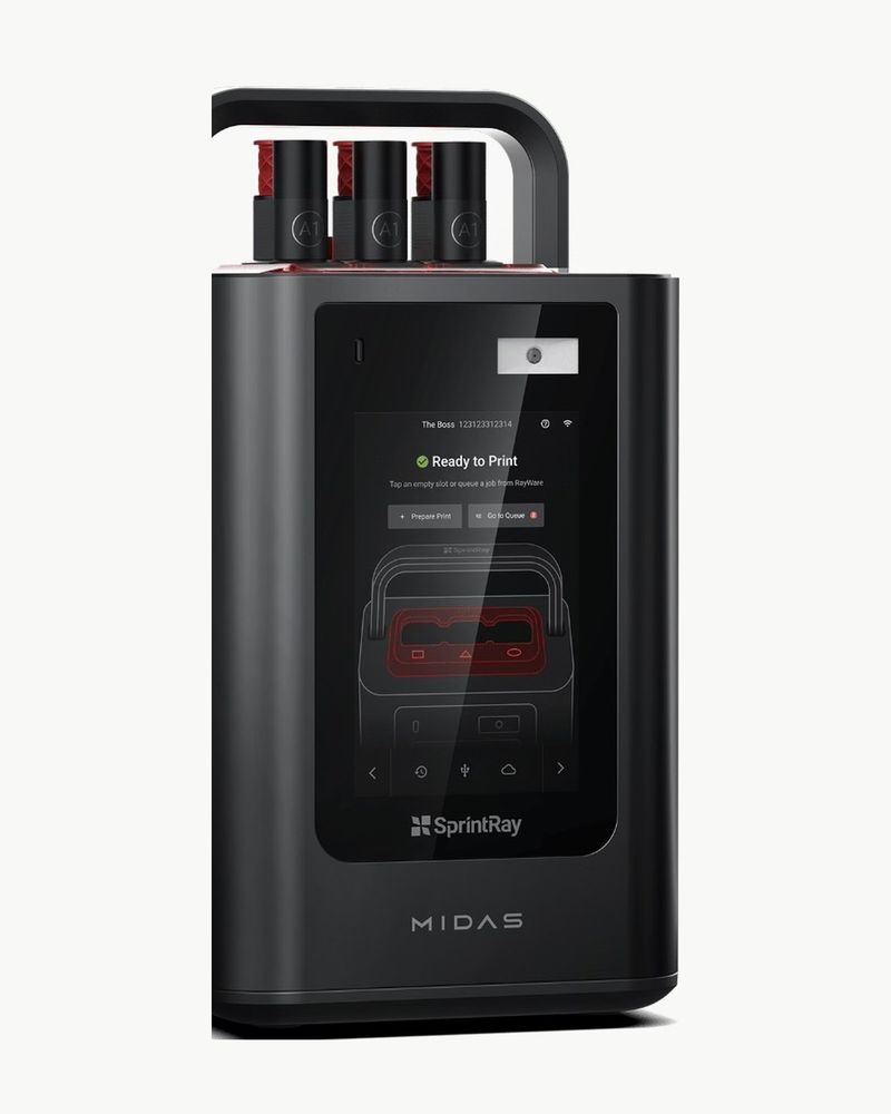 The SprintRay Midas digital press, with three capsules of hybrid ceramic loaded on top