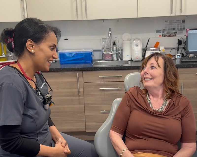 Radhika Baireddy talking with a patient in the surgery at Dentistry @ Jordanhill